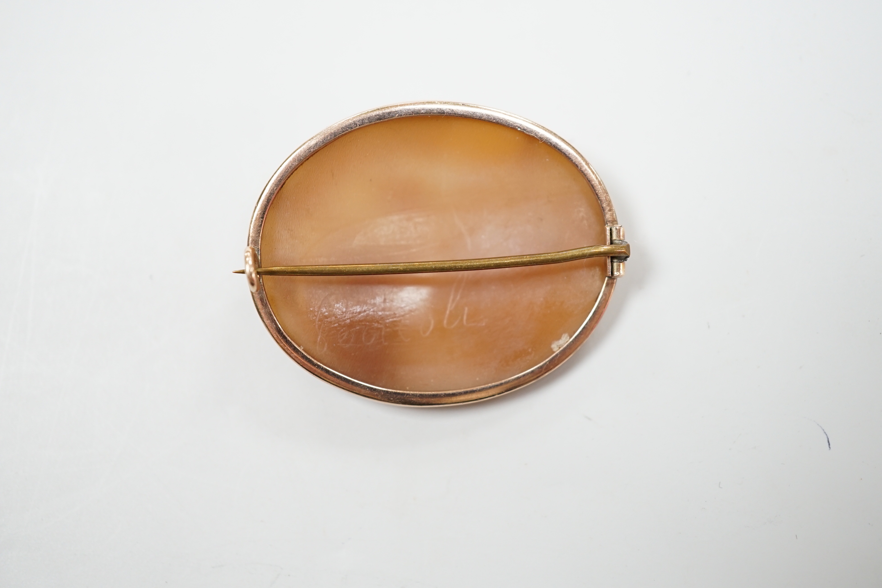 A gold mounted cameo brooch, carved with a classical family, width 4cm